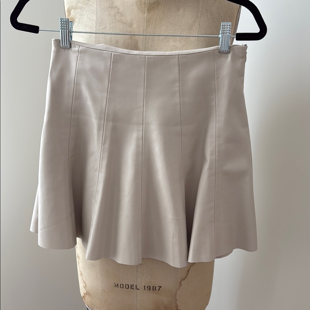 “Pleather” side zip short trumpet skirt
Lined. Liner is a short. Color is “nude”